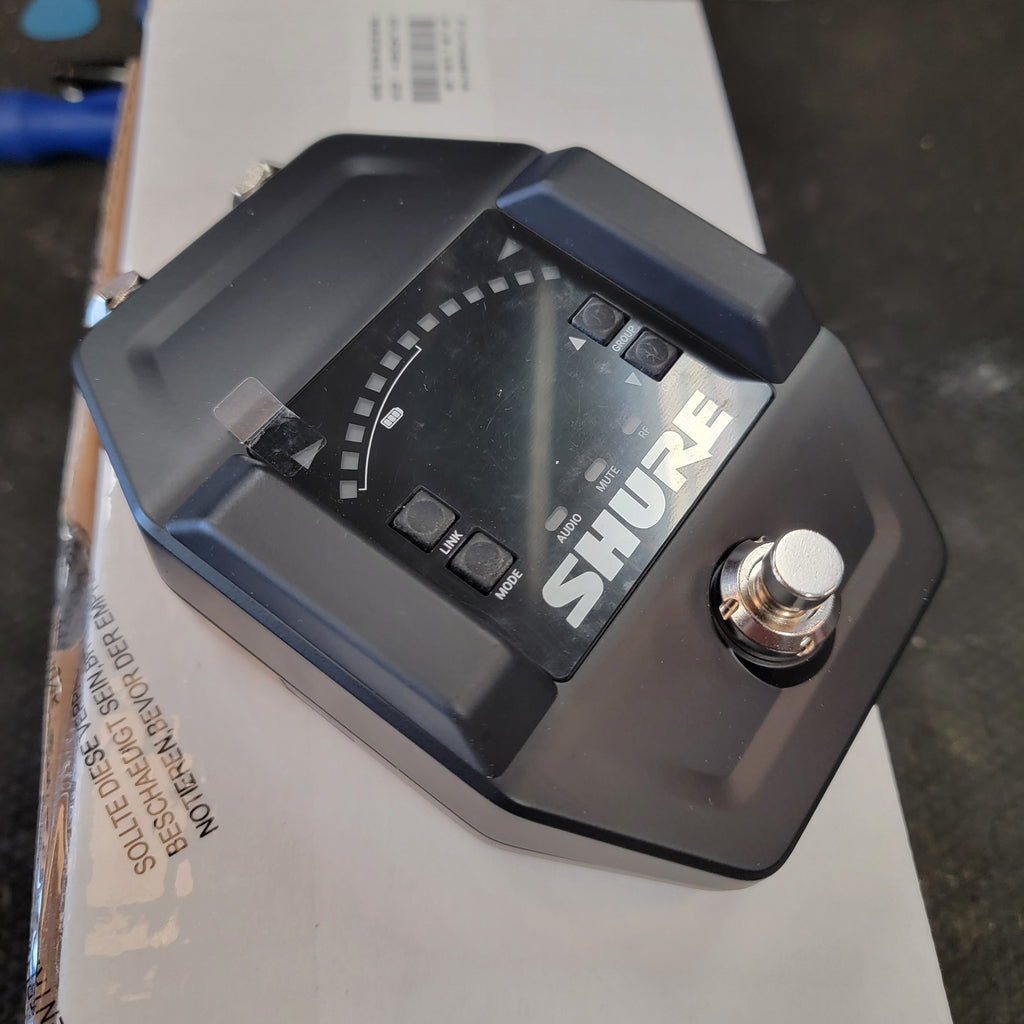 Shure GLXD6+ wireless guitar pedal receiver — black metal chassis angled top view