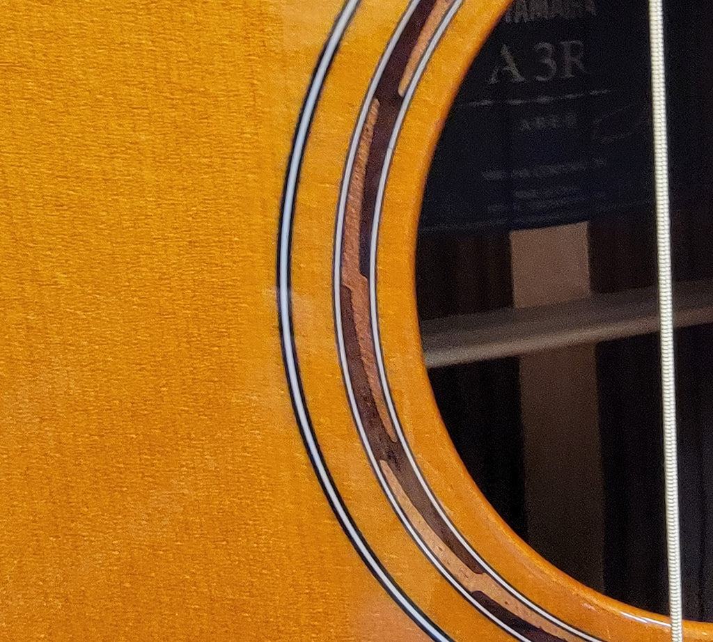 Yamaha A3R acoustic-electric guitar — endpin and strap button detail