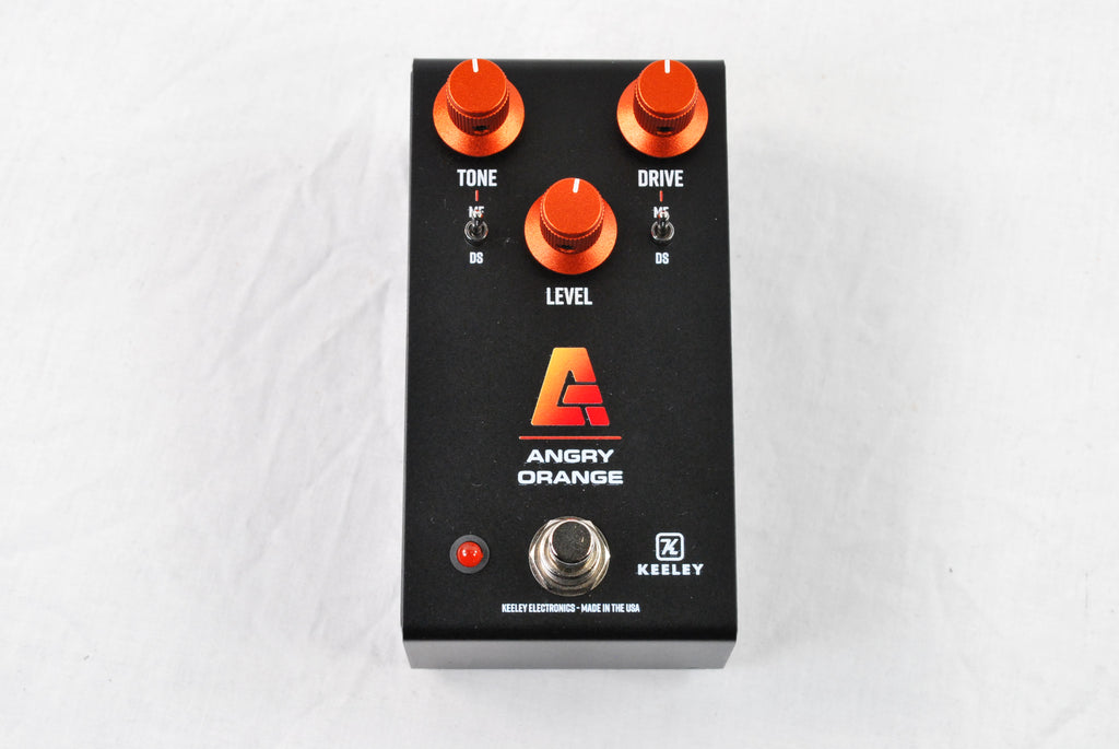 Used Keeley Angry Orange distortion fuzz pedal — black enclosure angled view