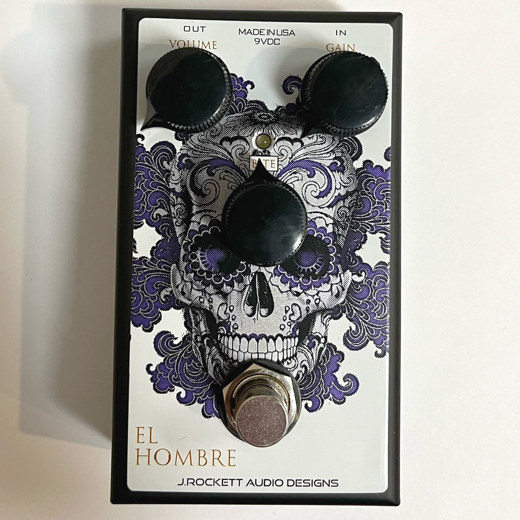 J. Rockett El Hombre overdrive pedal — white face with purple skull graphic, top view