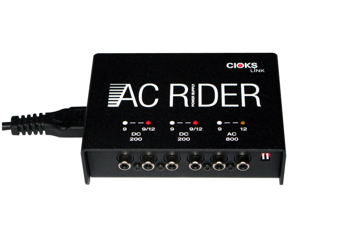 Cioks AC Rider Link power supply — angled view of output jacks and indicator LEDs