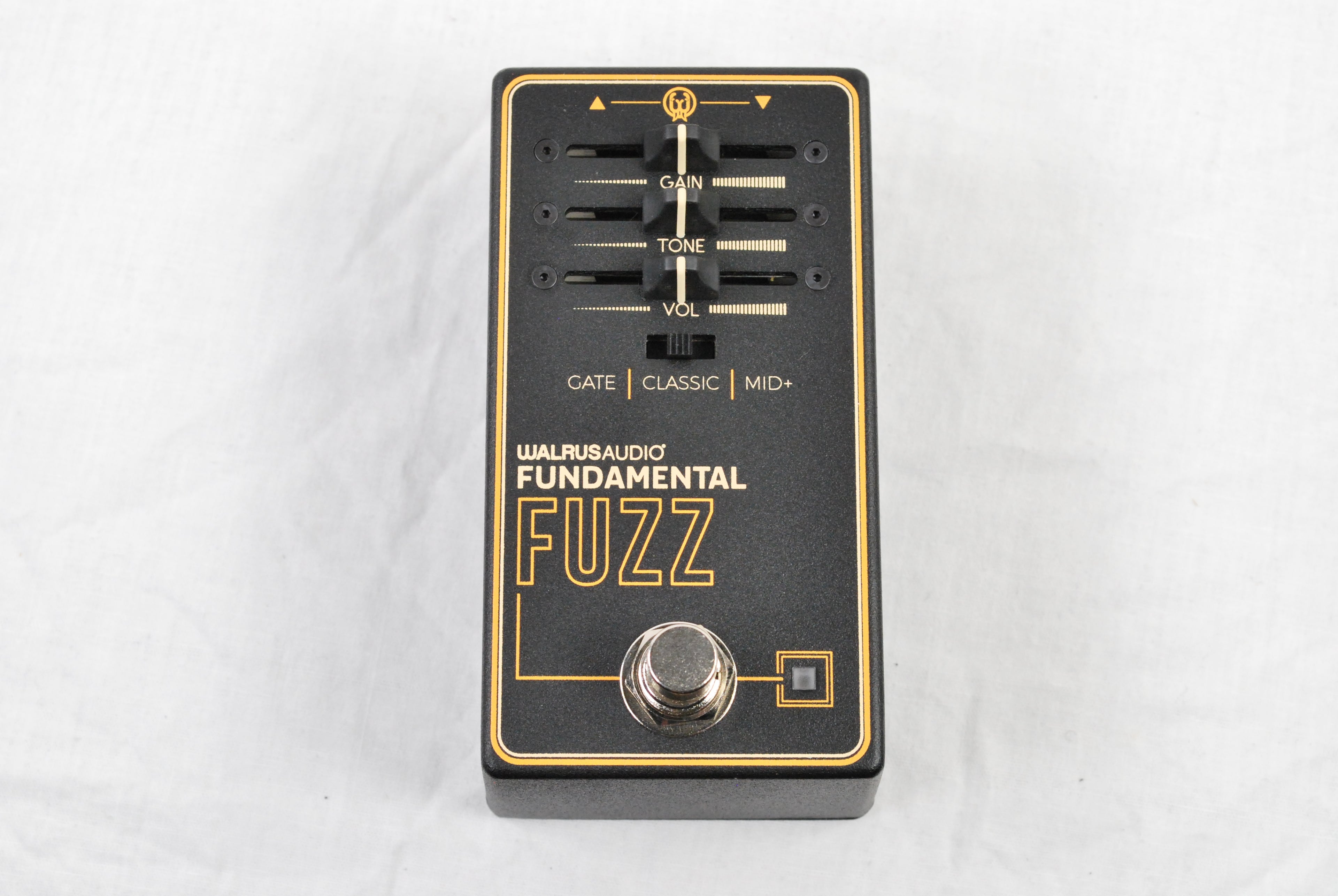 Walrus Audio Fundamental Fuzz pedal — angled top view on cloth