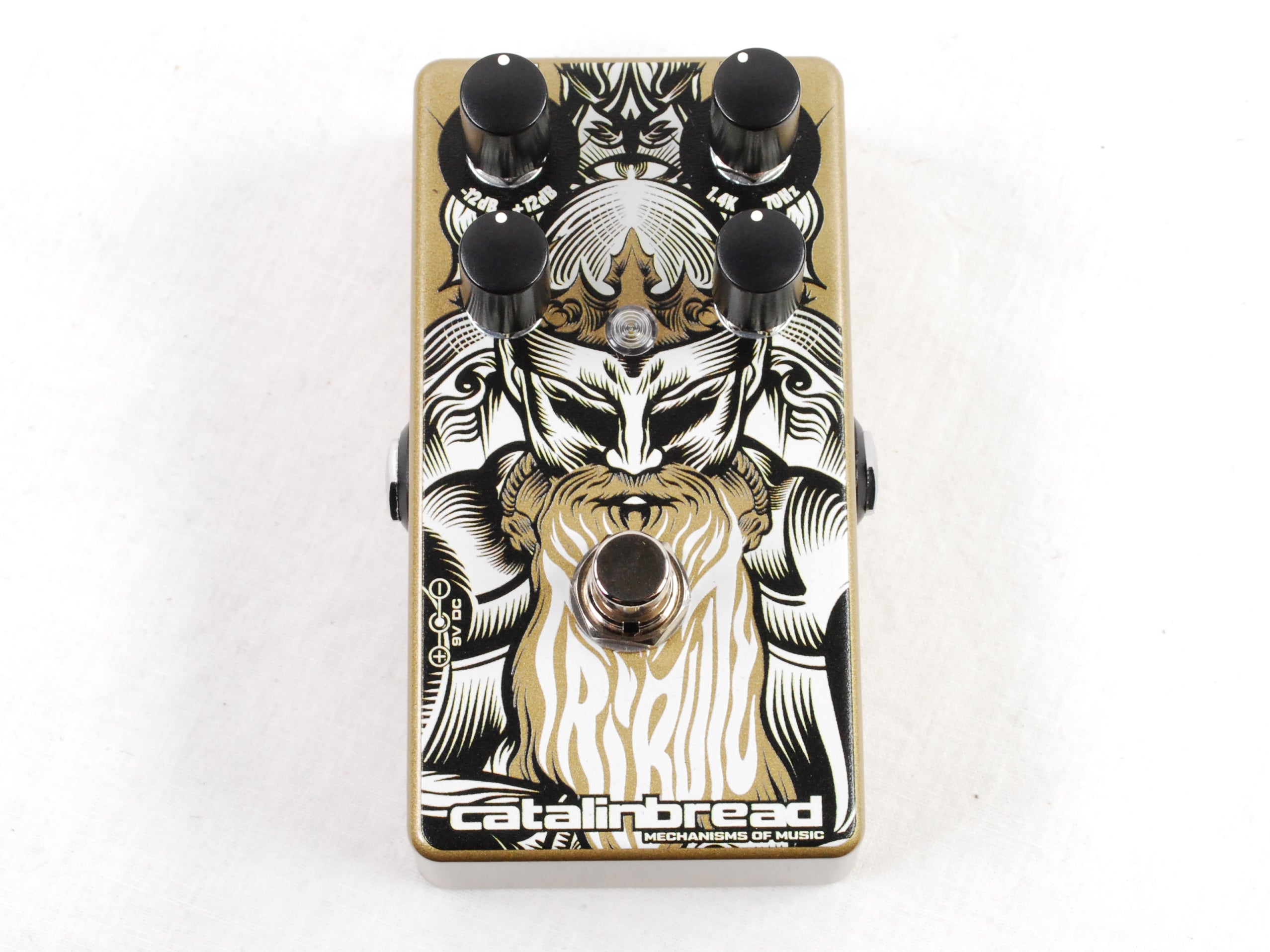 Used Catalinbread Tribute overdrive pedal — gold enclosure with black and white warrior artwork, top view
