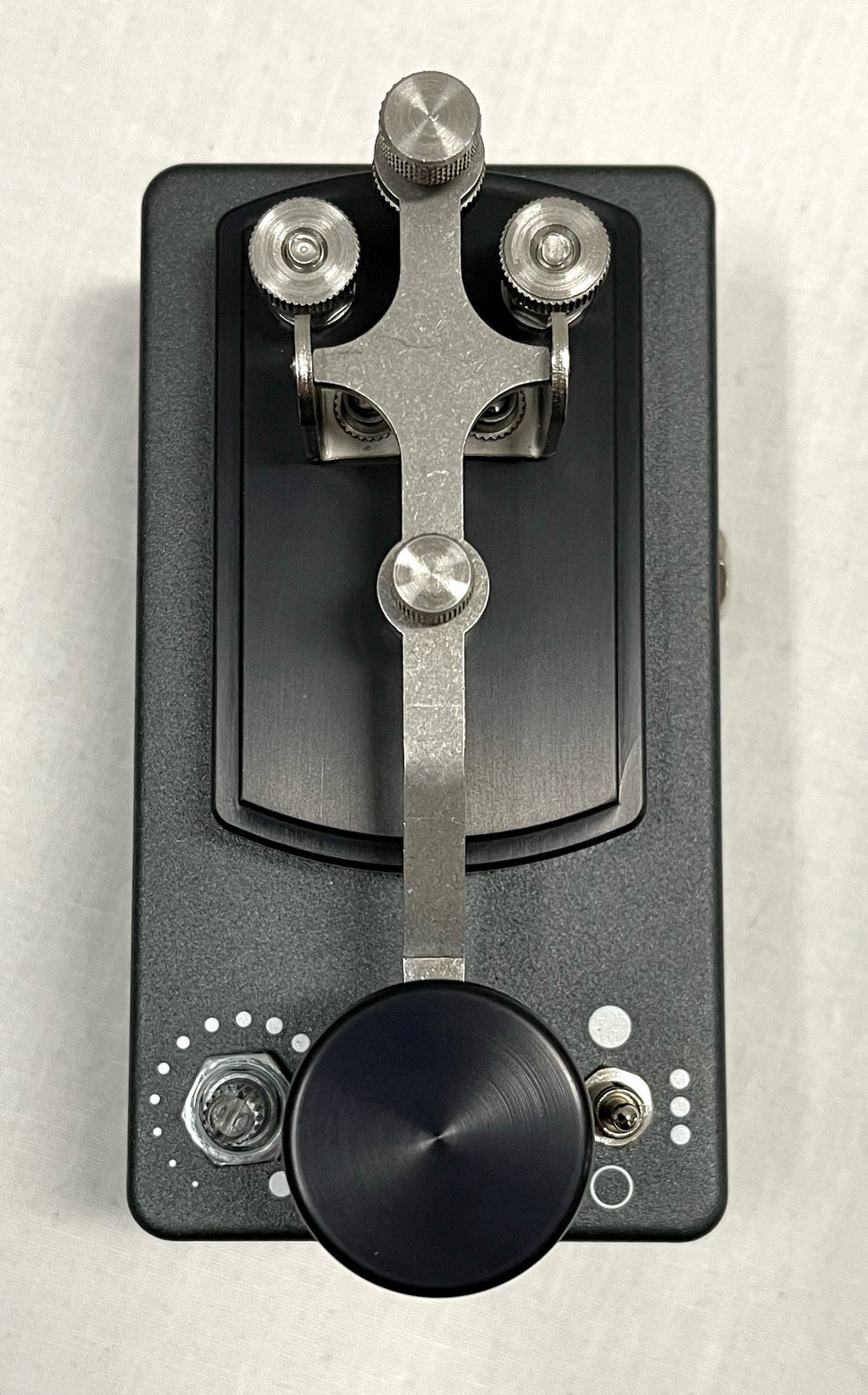 Coppersound Telegraph V2 killswitch pedal — detail of all-metal hardware on grey enclosure