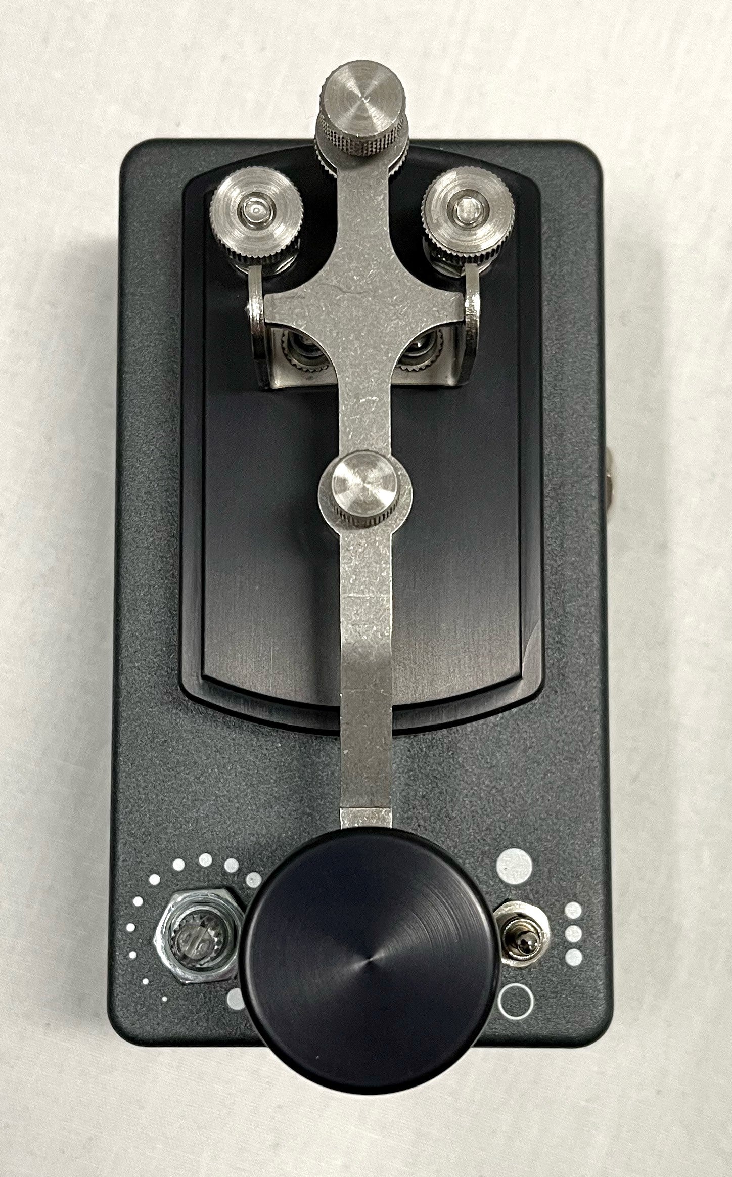 Coppersound Telegraph V2 killswitch pedal — detail of all-metal hardware on grey enclosure