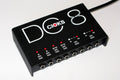 CIOKS DC8 pedal power supply — black enclosure top view showing 8 outputs and LED labels