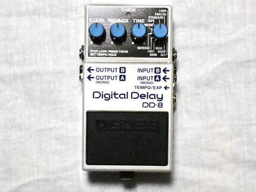 Boss DD-8 Digital Delay guitar pedal — silver enclosure with blue knobs, top view