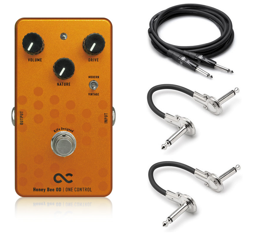 One Control Honey Bee Overdrive guitar pedal — orange enclosure with included cables