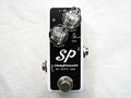 Xotic SP Compressor mini guitar pedal — black faceplate on white enclosure, top view