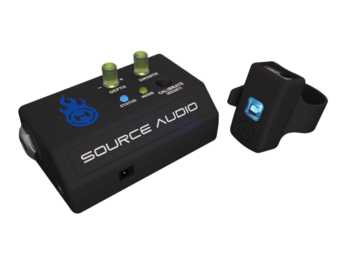 New Source Audio Hot Hand wireless effects controller receiver base station with green knobs and black motion sensor ring